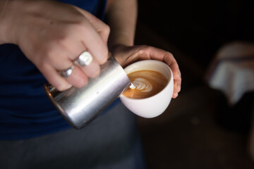 barista making a flat white coffee