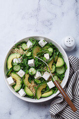 Green quinoa salad with cucumber, avocado and feta.