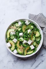 Green quinoa salad with cucumber, avocado and feta.
