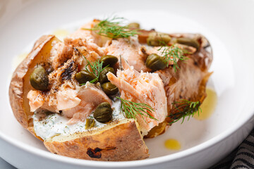Whole baked potato stuffed with salmon, yogurt sauce and capers.