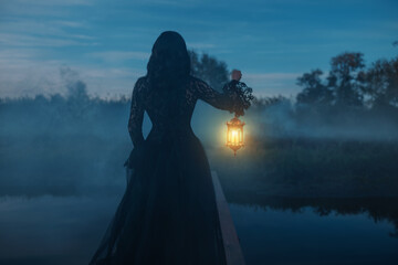 photo real person silhouette gothic woman hand hold lantern lamp walking across bridge over river...