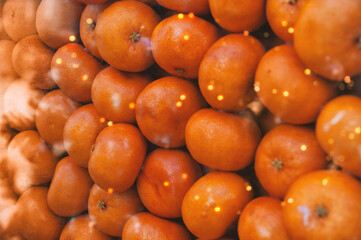 Fresh oranges create vibrant citrus background with festive glow