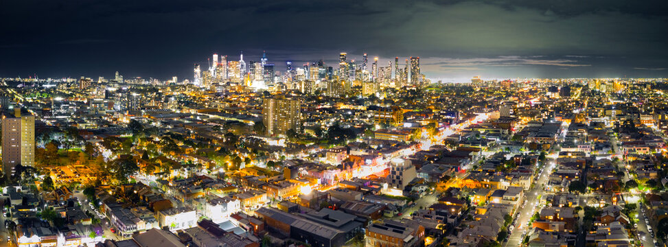 Aerial night time panorama of colourful lights of high rise buildings of a city skyline in Melbourne