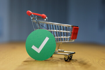 A miniature shopping cart with a green checkmark indicating the successful completion of an online...