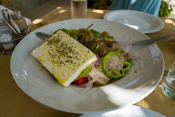 Greek salad in Europe, Greece, in summer, on a sunny day.