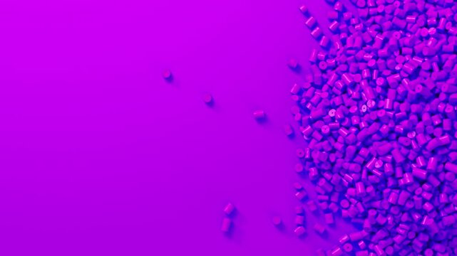 Closeup top view on violet plastic polypropylene granules heap rotating on violet backdrop, masterbatch polymer grain pile. HDPE or PVC resin pellets.