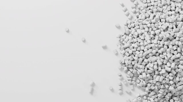 Closeup top view on white plastic polypropylene granules heap rotating on white backdrop, masterbatch polymer grain pile. HDPE or PVC resin pellets.