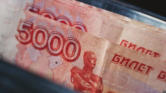 5000 Russian rubles in electronic money counting machine, accounting. Financial transaction in the bank. RUB Mortgage, Seller or broker considers finances. Economic crisis in Russia. Slow motion