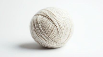 Ball of light cream yarn for craft projects, on white background