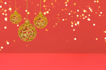 Christmas tree baubles on red background with golden lights. Festive winter holiday background. Design with copy space for greeting card, text, advertising, banner, invitation