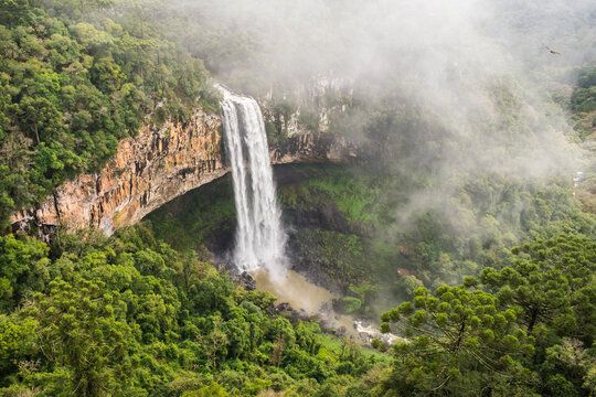 A view of Cascata do Caracol waterfall with fog at Caracol Park - Canela, Brazil