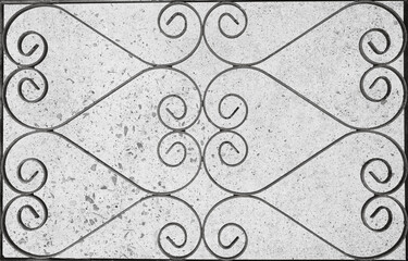Rusty, curly patterned, wrought gate irons.  Opposites background.