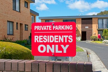 Private parking residents only sign on an apartment housing estate; a symbol of exclusive tenant...