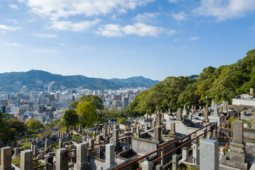 This landscape photo was taken in Asia, Japan, Kyushu, Nagasaki, in summer. It shows the Arakisotaro cemetery in Nagasaki, under the sun.