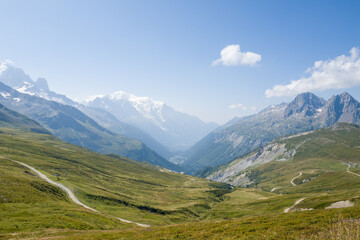 Obraz premium This landscape photo was taken in Europe, France, Auvergne Rhone Alpes, Haute Savoie, in summer. It shows the Chamonix Valley and Mont Blanc, under the Sun.