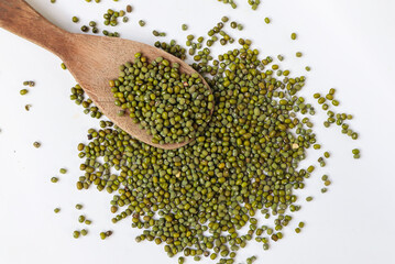 Close up Mung Bean Seed in wooden spoon with green mung beans background. Food ingredient. Top view