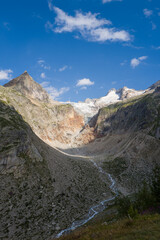 This landscape photo was taken in Europe, Italy, Aosta Valley, in summer. It shows the Pre de Bar glacier and Mount Dolent, under the sun.