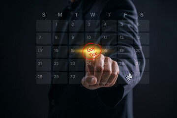 Businessman pointing at tax day on virtual calendar to highlight financial deadline and schedule filing tasks, representing important business reminder and tax payment planning