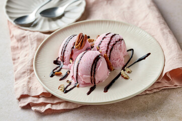 pink raspberry ice cream decorated with chocolate sauce on plate