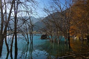 Lake Issyk in the rays of the setting sun. National Nature Park. Mountainous area with different vegetation.