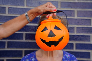 Person under Halloween pumpkin