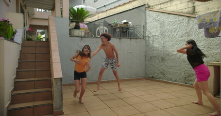 Children playing tag in courtyard, carefree chase, happiness, sibling bonding, laughter, energetic play, outdoors, family, fun