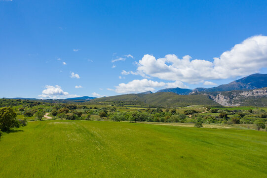 This landscape photo was taken in Europe, Spain, Aragon, Huesca, Samitier, in summer. It shows the fields and mountains around Bierge, under the Sun.