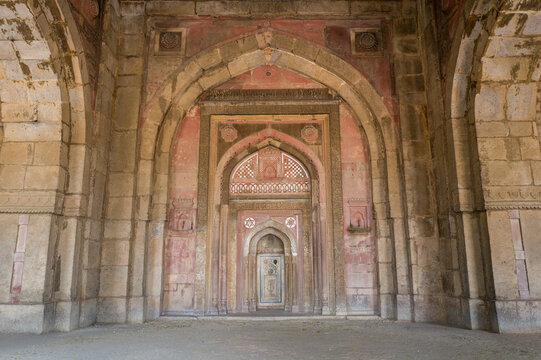 This landscape photo was taken in Asia, India, Delhi, Delhi, in summer. It shows the interior of the Jamali Kamali Mosque of the Mehrauli Archaeological Complex in Delhi, under the Sun.