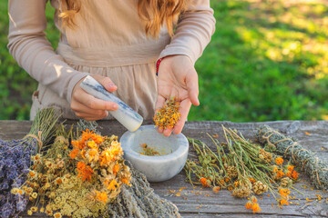 Woman with dried medicinal herbs. Selective focus.