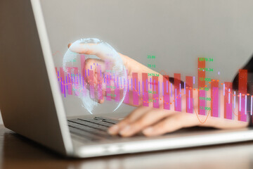 Business growth and global technology concept -hands on laptop, holographic graphs in air.