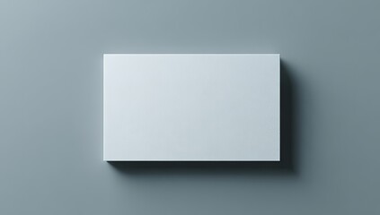 Top-down shot of a pristine rectangular card on a plain gray surface with soft shadowing