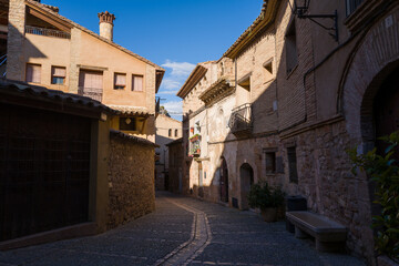 This landscape photo was taken in Europe, Spain, Aragon, Alquezar, in summer. It shows the alley of the city center in Alquezar, under the Sun.