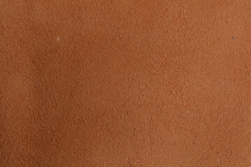 Detailed view of a rough, orange, textured surface, evoking warmth, comfort, and tactile sensations. Ideal for backgrounds, textures, and design