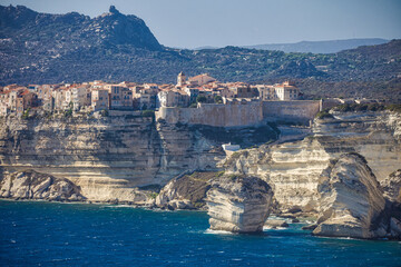 view of the medieval town of Bonifacio with its white limestone coastline with sunshine and blue skies