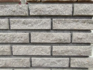 rectangular stone-like wall tiles arranged in a brick pattern