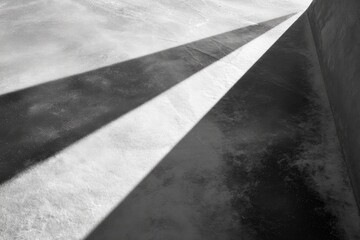 Fototapeta premium Abstract black and white image showing dramatic shadows across a textured surface