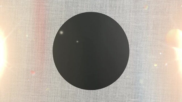 Black luminous sphere with grey cotton fabric background.