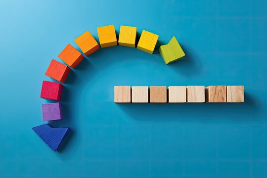 Vivid wooden blocks arranged in a curved path, suggesting a transition on a bright blue surface