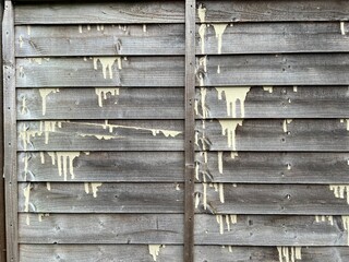 Aged wooden fence with horizontal planks, visible paint droplets and vertical rails. The grunge texture makes it excellent for design backgrounds, craft, and architectural projects.