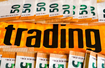 close up 50 euros banknotes and the word "trading"