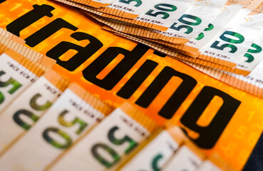 close up 50 euros banknotes and the word "trading"