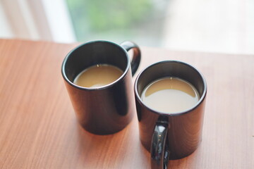 2 glasses of hot cappuccino coffee on the table