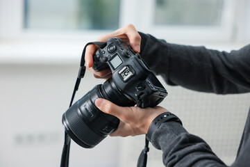 Professional photographer with camera in studio, closeup