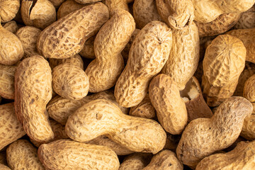 Unshelled raw peanuts, macro, top view.
