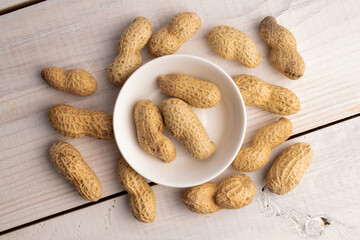 Unshelled raw peanuts, macro, top view.