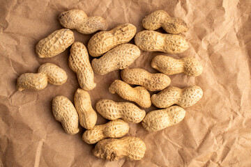 Unshelled raw peanuts, macro, top view.
