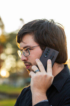 Man outdoors talking on phone calling his mum