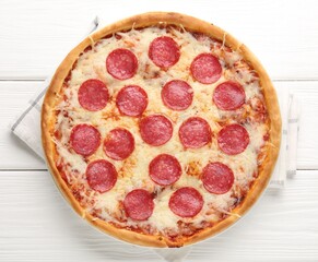 Delicious pepperoni pizza on white wooden background, top view
