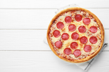 Delicious pepperoni pizza on white wooden background, top view. Space for text