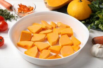 Fresh pumpkins and ingredients on white wooden table, closeup